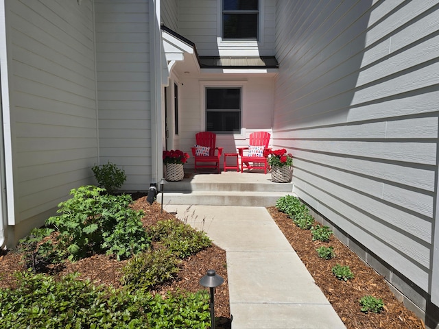 view of exterior entry with a porch
