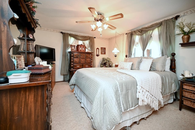 bedroom with a ceiling fan and light colored carpet