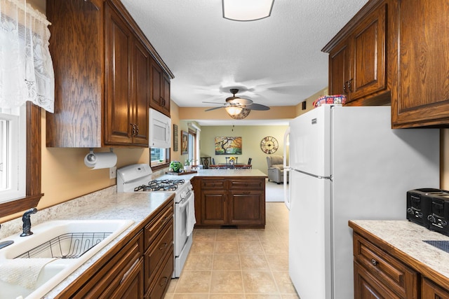 10851 Olive St NW, Coon Rapids, MN 55448 - kitchen featuring white appliances, light countertops, a sink, a ceiling fan, and light tile patterned floors