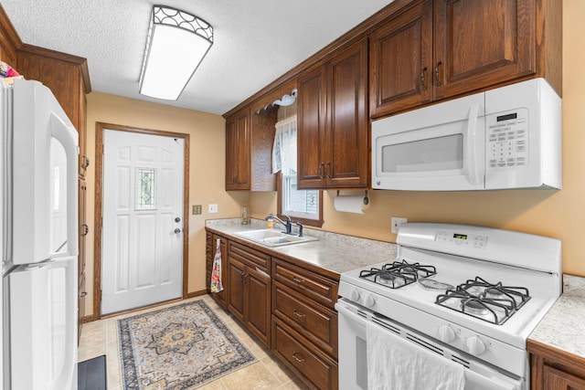 10851 Olive St NW, Coon Rapids, MN 55448 - kitchen with white appliances, a sink, light countertops, and a textured ceiling