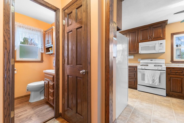 10851 Olive St NW, Coon Rapids, MN 55448 - kitchen featuring white appliances and light countertops