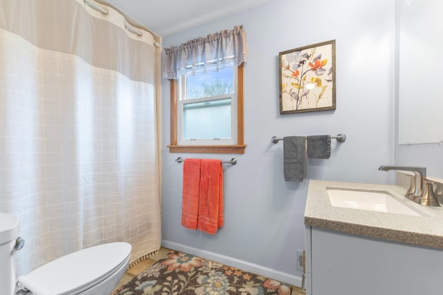 10851 Olive St NW, Coon Rapids, MN 55448 - full bathroom with toilet, vanity, a shower with curtain, and baseboards