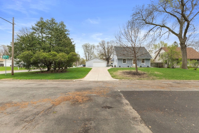 10851 Olive St NW, Coon Rapids, MN 55448 - view of front of house featuring a front yard, a detached garage, and an outdoor structure