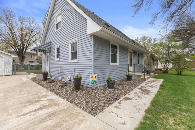 10851 Olive St NW, Coon Rapids, MN 55448 - view of side of home with a lawn