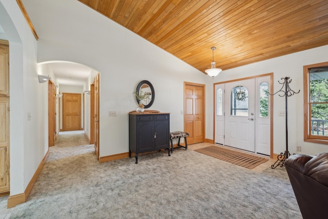 5301 Pine Beach Rd, Brainerd, MN 56401 - foyer entrance with arched walkways, vaulted ceiling, wood ceiling, baseboards, and carpet