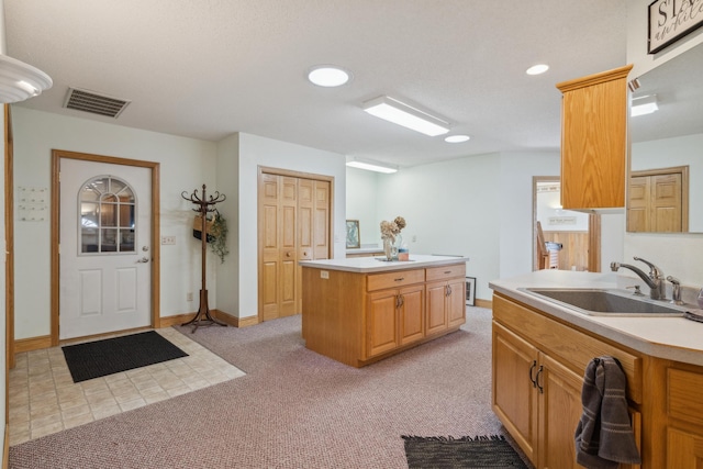 5301 Pine Beach Rd, Brainerd, MN 56401 - kitchen featuring a sink, light colored carpet, light countertops, a kitchen island, and recessed lighting