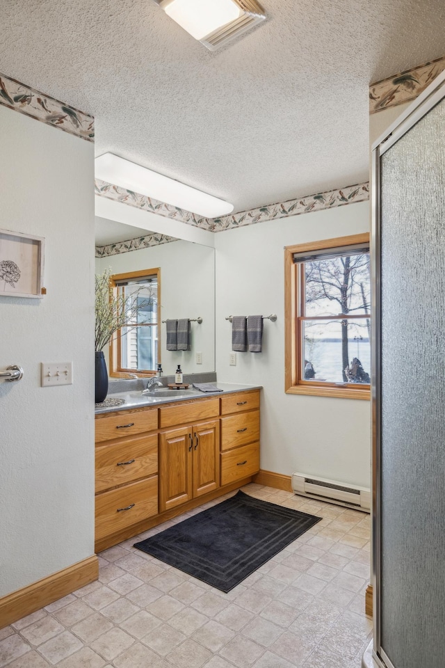 5301 Pine Beach Rd, Brainerd, MN 56401 - full bath with a baseboard radiator, healthy amount of natural light, baseboards, vanity, and a textured ceiling