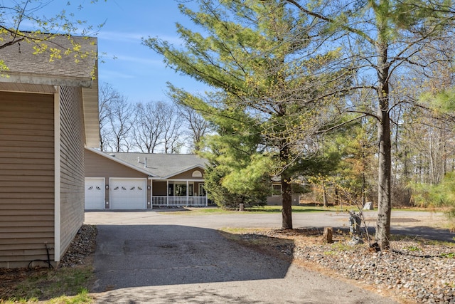 5301 Pine Beach Rd, Brainerd, MN 56401 - view of side of home with driveway and an attached garage