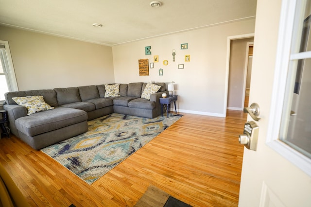 living area featuring baseboards and wood finished floors