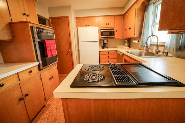kitchen featuring a sink, appliances with stainless steel finishes, and light countertops