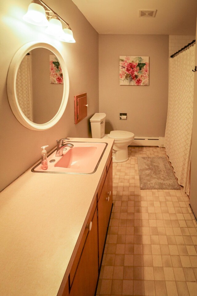 bathroom featuring tile patterned flooring, vanity, toilet, a baseboard radiator, and visible vents