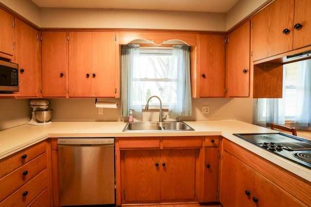 kitchen featuring light countertops, a sink, and stainless steel appliances