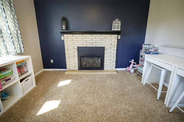 living room with carpet floors, baseboards, and a brick fireplace