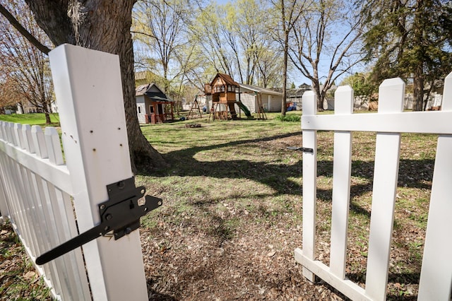 exterior space with fence and a playground