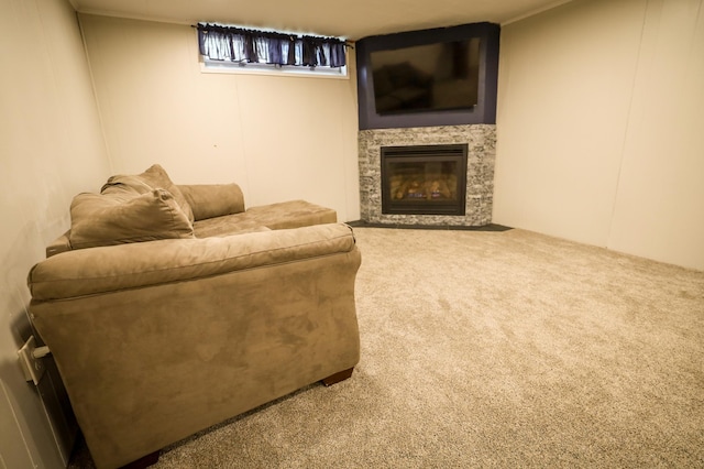 carpeted living area featuring a glass covered fireplace