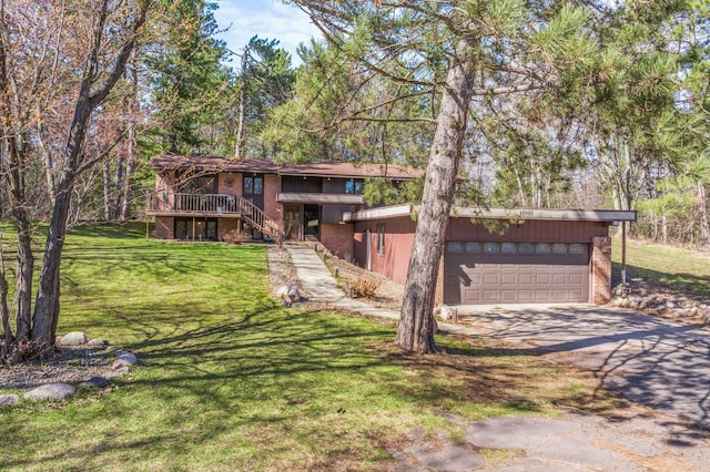 view of front facade featuring stairs, a front lawn, brick siding, a deck, and driveway