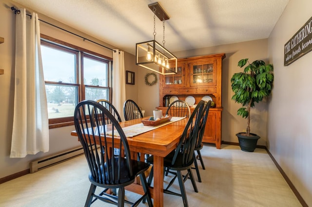 dining space with a textured ceiling, baseboards, a baseboard radiator, a notable chandelier, and light carpet