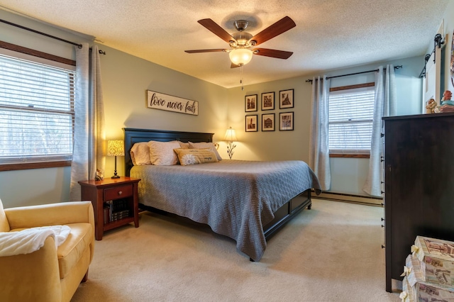bedroom featuring light colored carpet, multiple windows, and baseboard heating