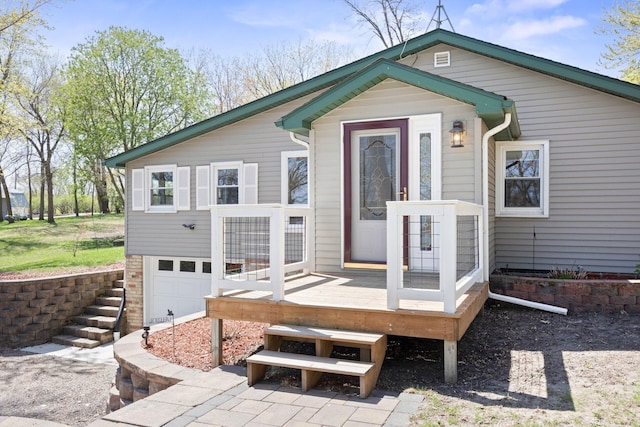19797 612th Ave, Litchfield, MN 55355 - rear view of property with an attached garage, a wooden deck, and stairway