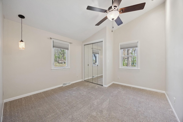 19797 612th Ave, Litchfield, MN 55355 - unfurnished bedroom featuring carpet, multiple windows, lofted ceiling, and baseboards