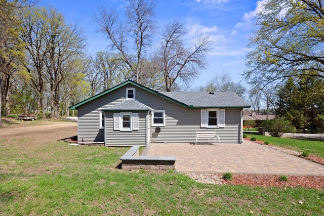 19797 612th Ave, Litchfield, MN 55355 - rear view of house featuring a yard, a patio area, and roof with shingles