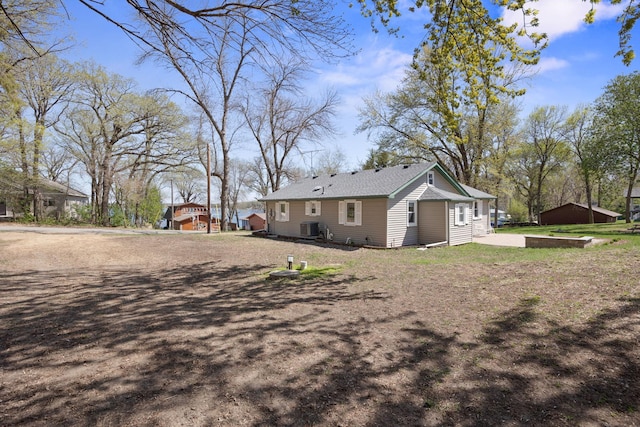 19797 612th Ave, Litchfield, MN 55355 - back of property featuring central air condition unit and a lawn