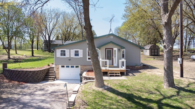 19797 612th Ave, Litchfield, MN 55355 - view of front of home with driveway, a shed, an attached garage, a front yard, and an outbuilding