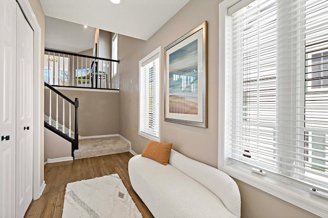 living area featuring wood finished floors, baseboards, and recessed lighting