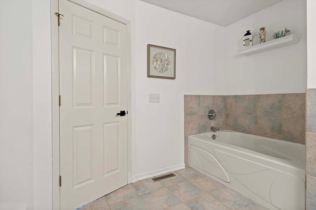 bathroom with a garden tub and baseboards