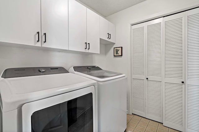 washroom with washer and dryer and cabinet space
