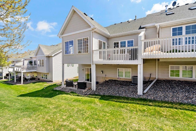 rear view of house with a yard, a patio, and a deck