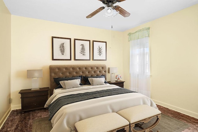 carpeted bedroom with baseboards and a ceiling fan