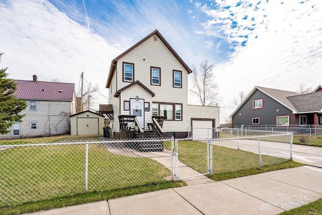 view of front facade featuring concrete driveway, a front yard, a fenced front yard, and a storage shed