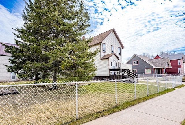 view of front of home with fence and a front yard
