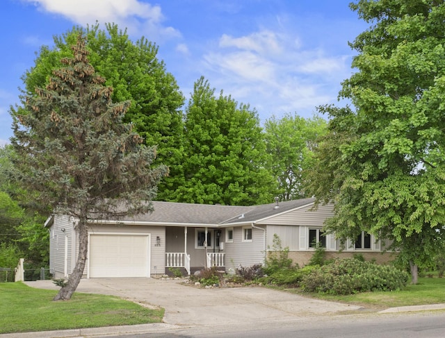 615 9th Ave SW, Faribault, MN 55021 - view of front of property featuring a garage, driveway, a porch, and brick siding
