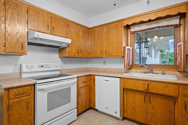 615 9th Ave SW, Faribault, MN 55021 - kitchen featuring white appliances, under cabinet range hood, a sink, light countertops, and brown cabinetry