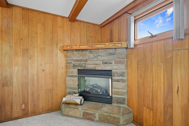 615 9th Ave SW, Faribault, MN 55021 - detailed view of wood walls, beam ceiling, carpet, and a fireplace
