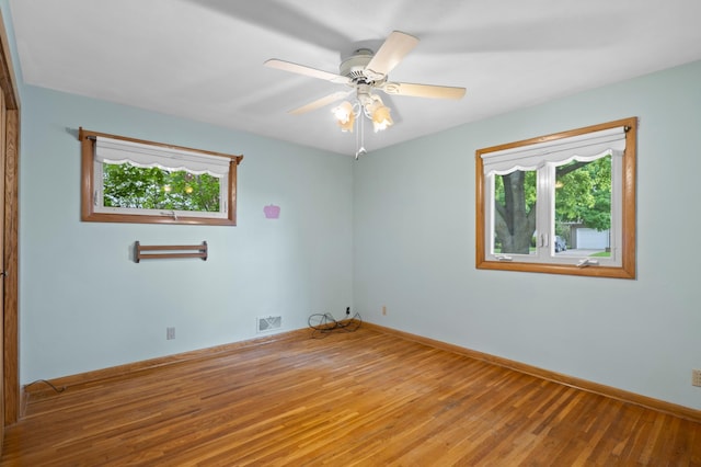 615 9th Ave SW, Faribault, MN 55021 - empty room with wood finished floors, baseboards, and ceiling fan