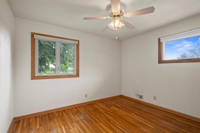 615 9th Ave SW, Faribault, MN 55021 - empty room with healthy amount of natural light, wood finished floors, and baseboards