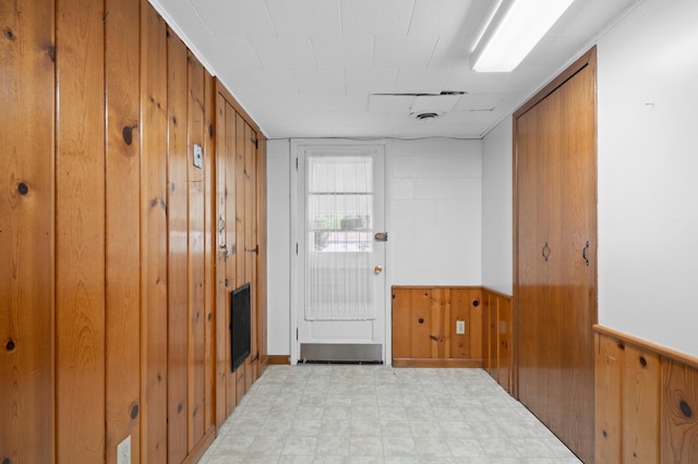 615 9th Ave SW, Faribault, MN 55021 - hall with wooden walls, light flooring, and wainscoting