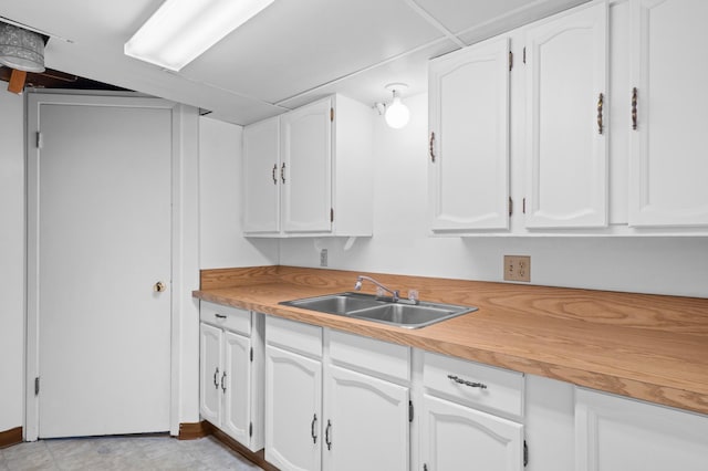 615 9th Ave SW, Faribault, MN 55021 - kitchen featuring a sink and white cabinetry
