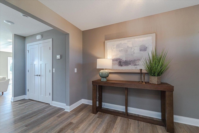 foyer with baseboards and wood finished floors