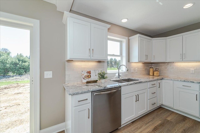 kitchen with a sink, dark wood finished floors, dishwasher, and white cabinets