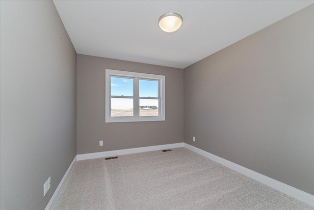 unfurnished room featuring carpet floors, baseboards, and visible vents
