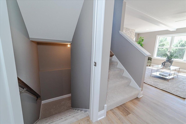 stairs with baseboards and wood finished floors