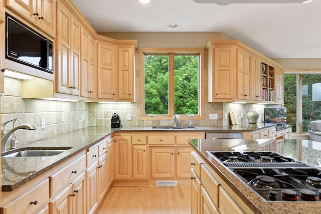 809 Saint Moritz, Victoria, MN 55386 - kitchen with black appliances, a sink, light brown cabinetry, healthy amount of natural light, and recessed lighting