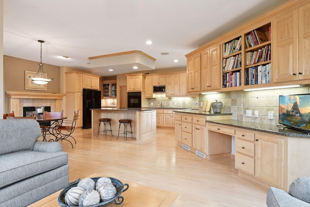 809 Saint Moritz, Victoria, MN 55386 - kitchen with black appliances, light brown cabinets, a breakfast bar area, light wood-type flooring, and decorative backsplash