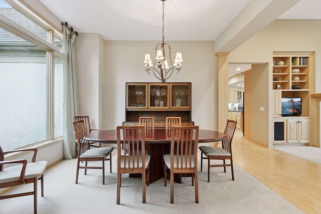 809 Saint Moritz, Victoria, MN 55386 - dining room with healthy amount of natural light, a chandelier, light carpet, and light wood-type flooring
