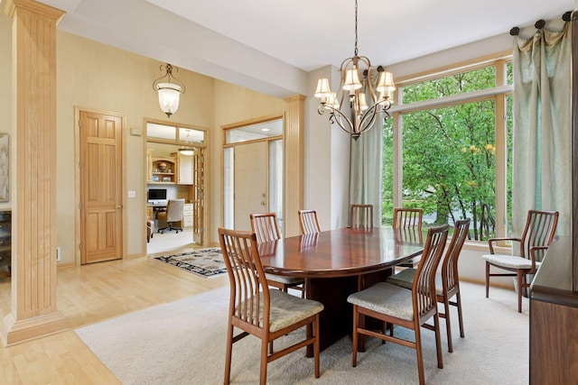 809 Saint Moritz, Victoria, MN 55386 - dining area featuring an office area, light wood-style flooring, a chandelier, and baseboards