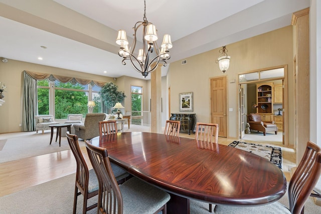 809 Saint Moritz, Victoria, MN 55386 - carpeted dining space with healthy amount of natural light, a high ceiling, a chandelier, and recessed lighting